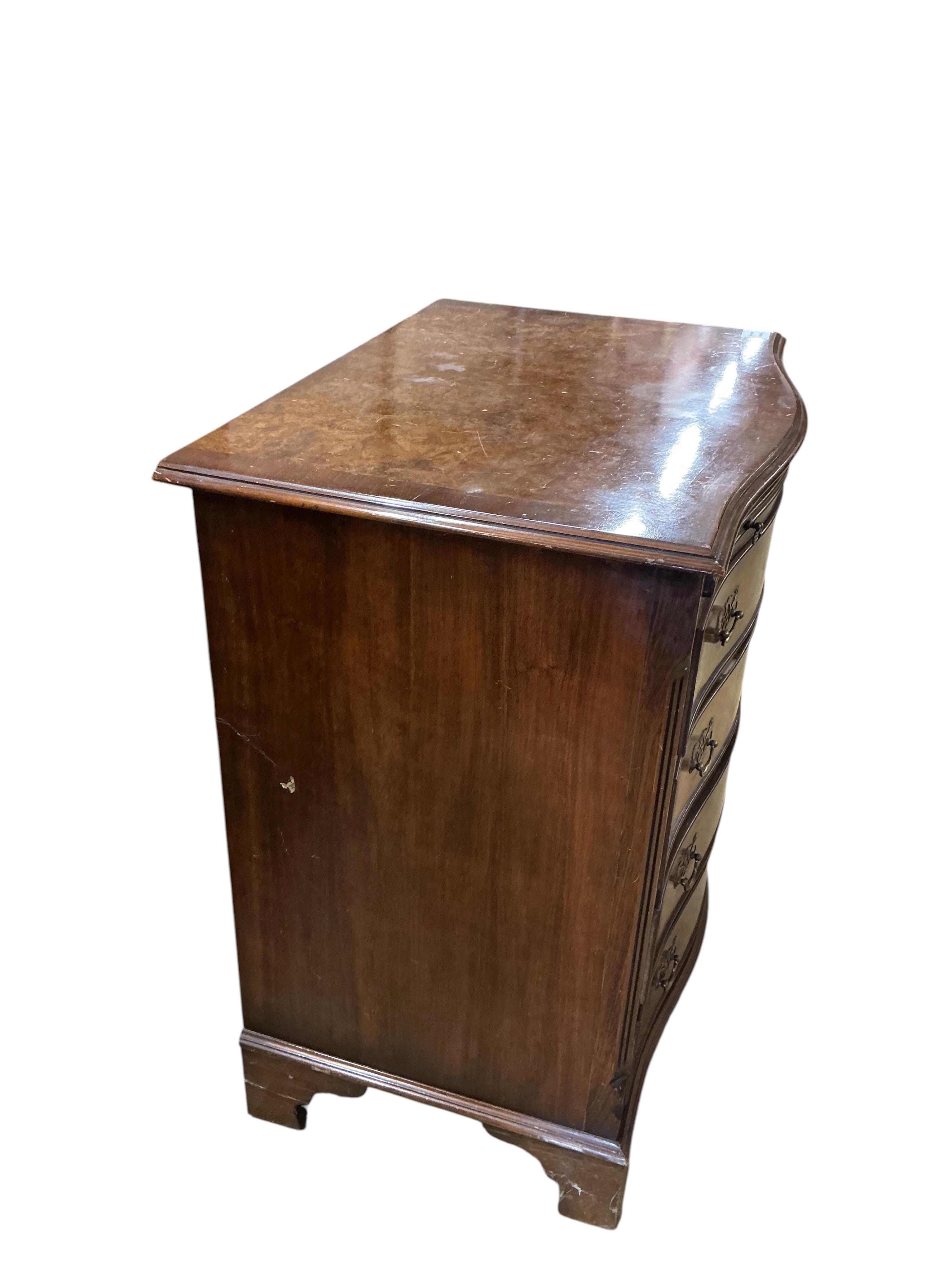 A reproduction George I style walnut serpentine four drawer chest, with brushing slide, width 70cm, depth 48cm, height 77cm